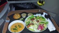 a plate of salad and soup on a table
