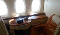 a table with a seat and windows in a plane