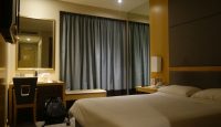 a hotel room with a bed and a mirror