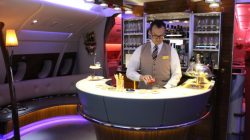a man standing behind a bar