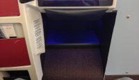 a person's feet in a seat with a tv