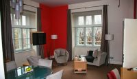 a living room with a table and chairs