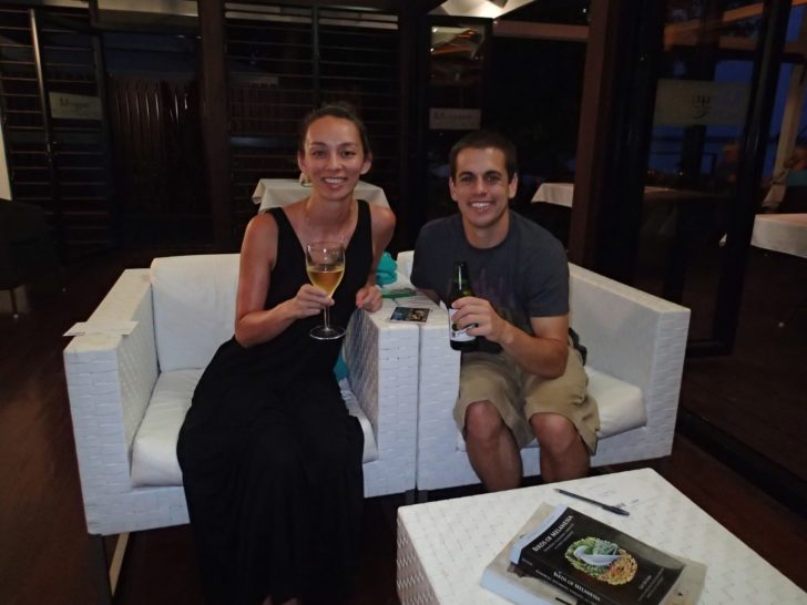 a man and woman sitting on a white couch