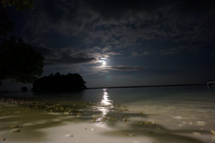 a moon over a body of water