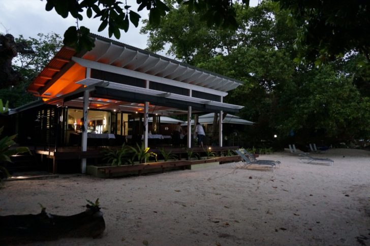 a building with a deck and chairs in the front