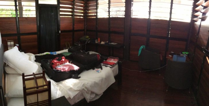 a room with a bed and luggage