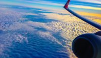 an airplane wing and clouds
