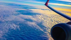an airplane wing and clouds