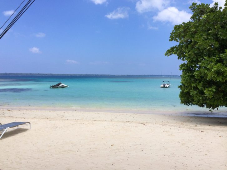 a beach with boats in the water