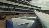 a plane wing in front of a building
