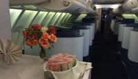 a table with flowers and a bunch of snacks on it