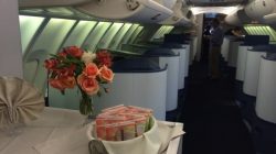 a table with flowers and a bunch of snacks on it