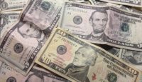 a pile of money with different denominations
