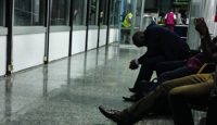 a group of people sitting on benches in a hallway