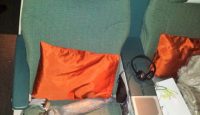 a seat with a pillow and headphones on it