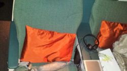 a seat with a pillow and headphones on it
