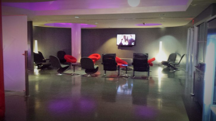 a room with chairs and a television
