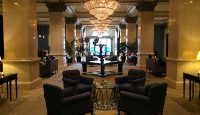 a room with chandeliers and chairs