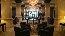 a room with chandeliers and chairs