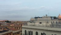 a group of buildings with a cloudy sky