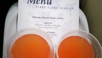 two glasses of orange liquid on a tray