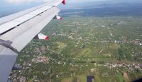 an airplane wing and a landscape