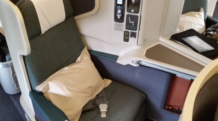 a seat with a seat belt and a pillow