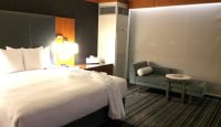 a hotel room with a bed and a chair