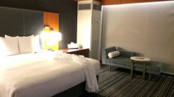 a hotel room with a bed and a chair