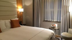 a bed with a lamp and a table in a room