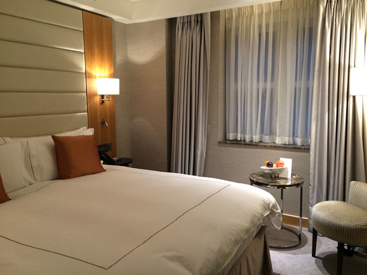 a bed with a lamp and a table in a room