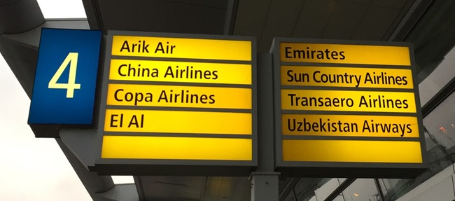 a sign board with different cities
