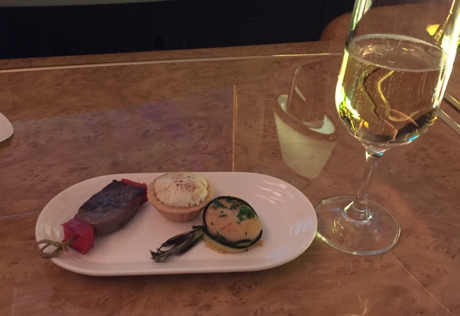 a plate of food and a glass of wine