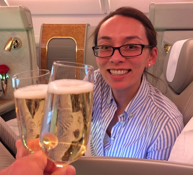 a woman holding up two glasses of champagne