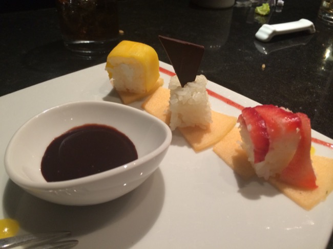 a plate of sushi with a sauce
