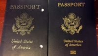 two black passport with gold text