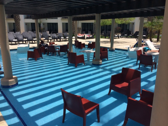 a pool with chairs and a table