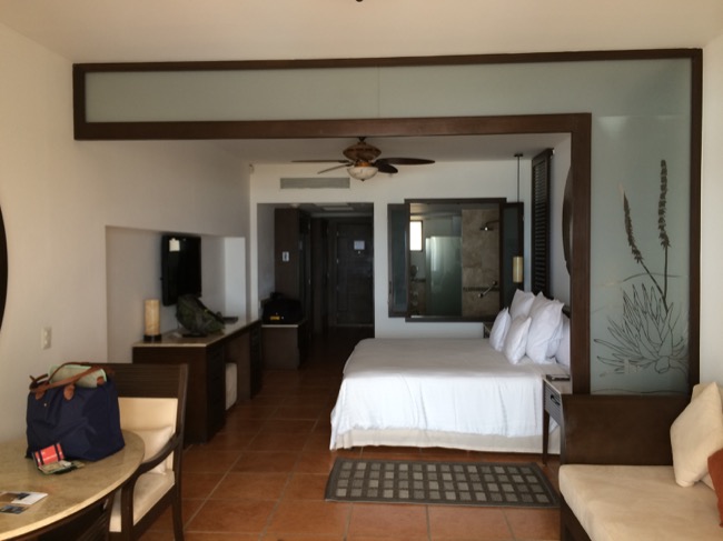 a room with a bed and chairs