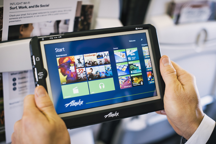 hands holding a tablet with a screen