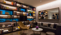 a room with a couch and bookshelves