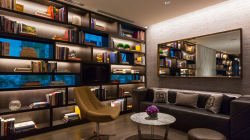 a room with a couch and bookshelves