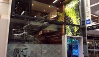 a glass wall with a sign on the side
