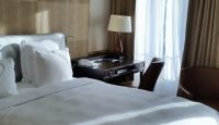 a bed with a lamp and a table in a room