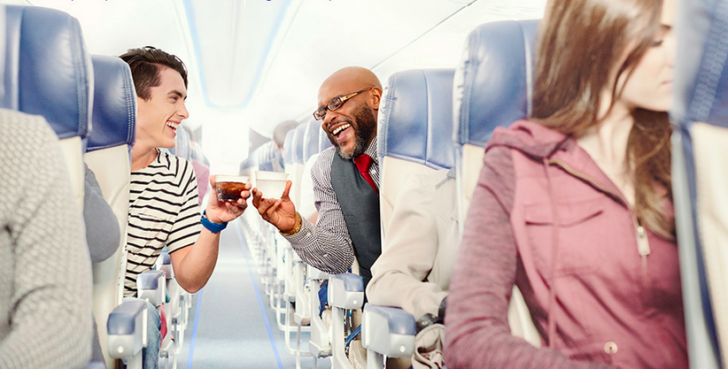 a man giving a drink to a woman
