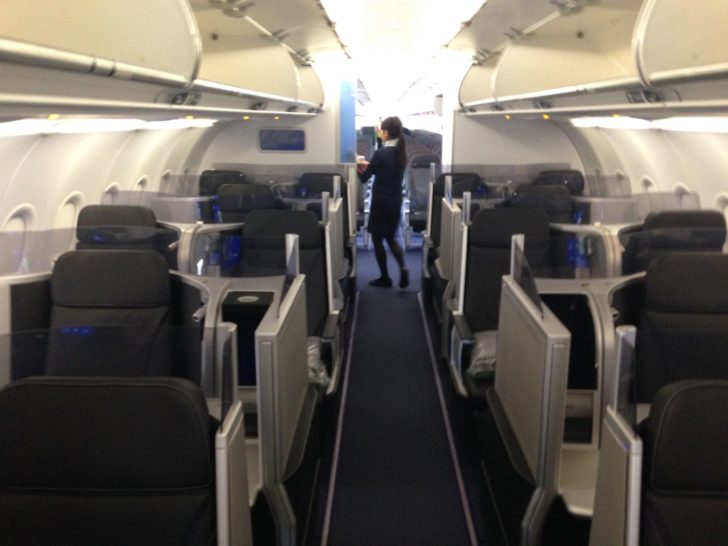 a woman standing in an airplane