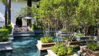 a pool with trees and chairs