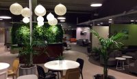 a room with tables and chairs and plants