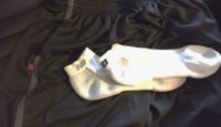 a pair of white socks and black pants