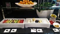 a plate of fruit and cheese on a table