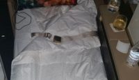 a bed with a pillow and a belt